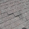 Wind damage to roof shingles in Florida - creased shingles